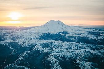 Aerial View of Snow-Capped Mountain Peak at Sunset