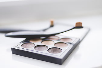 Neutral Eyeshadow Palette with Makeup Brushes on White Background