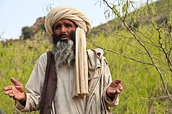 Portrait of elderly man in traditional turban and vest outdoors