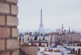 Paris Rooftops with Eiffel Tower in Hazy Background