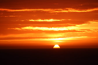 Vibrant orange sunset over the ocean horizon