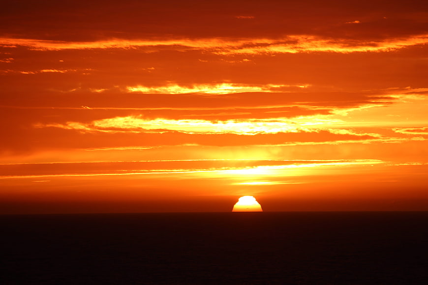 Vibrant orange sunset over the ocean horizon