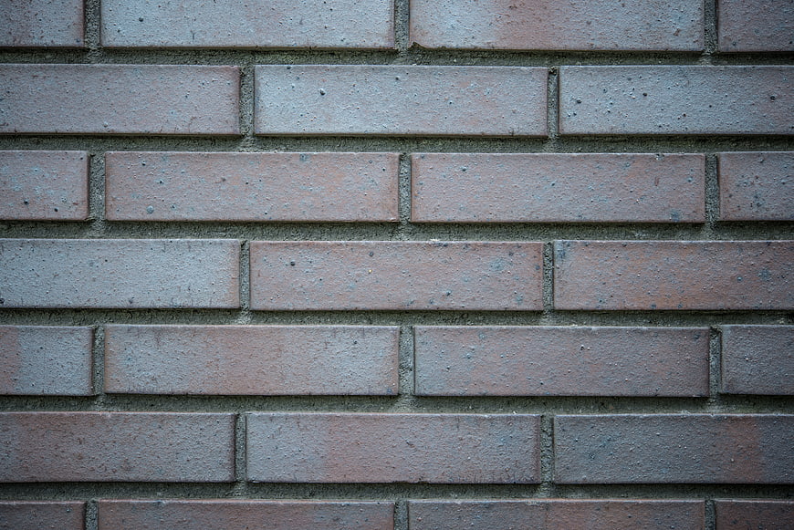 Close-up texture of weathered red brick wall pattern