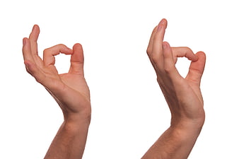 Hands making OK sign gesture on white background