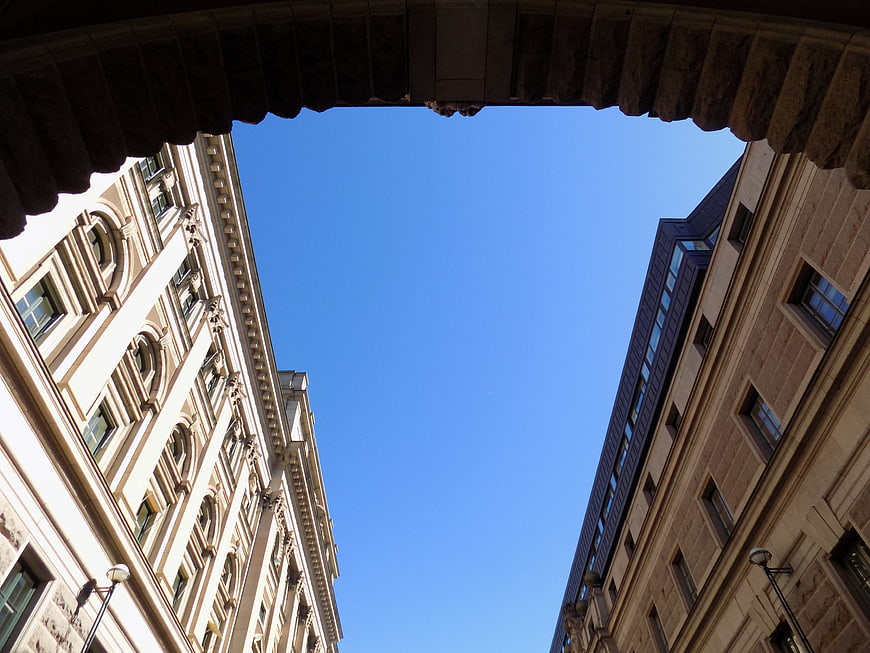 Low angle view of historic buildings through stone archway