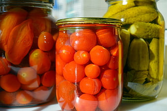 Glass Jars of Pickled Cherry Tomatoes and Cucumbers