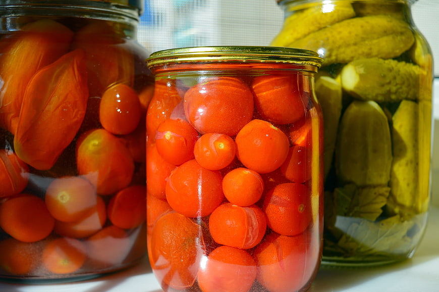Glass Jars of Pickled Cherry Tomatoes and Cucumbers