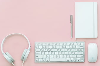Minimalist Pink Workspace with White Keyboard and Headphones