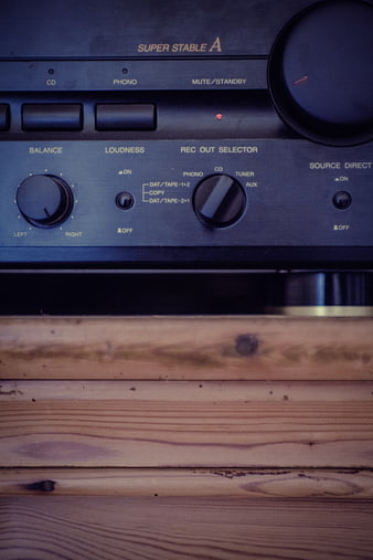 Vintage Stereo Receiver on Wooden Shelf