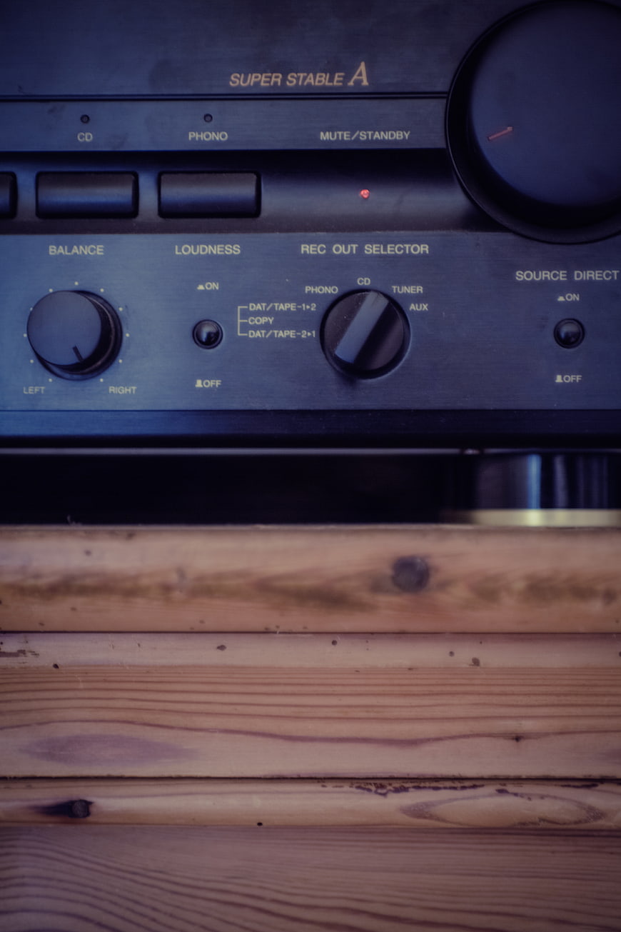 Vintage Stereo Receiver on Wooden Shelf