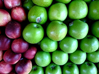 Fresh green apples and red plums close-up pattern