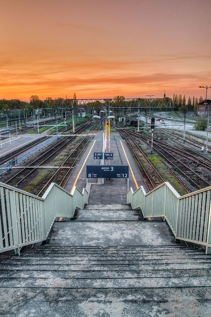 Empty Train Station Platform at Sunset with Stairs