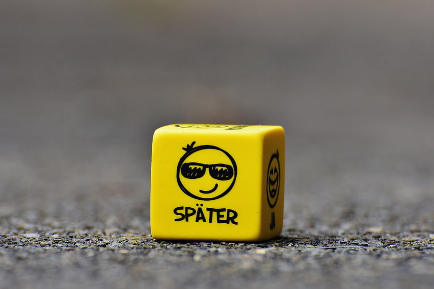 Yellow Dice with Smiley Face and German Text Später