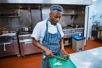 Professional Chef Chopping Vegetables in Commercial Kitchen