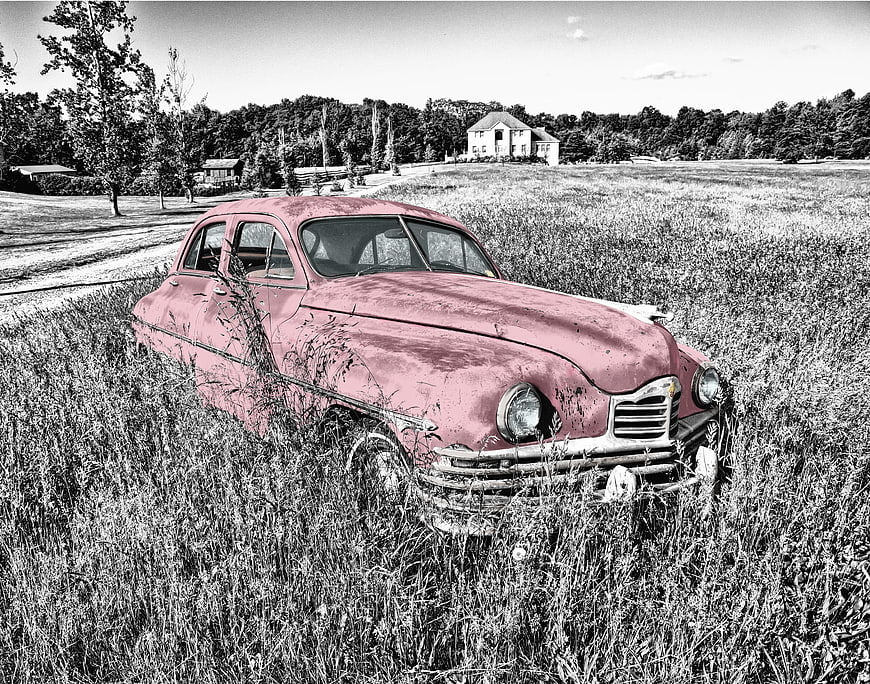Vintage Pink Car Abandoned in Overgrown Field