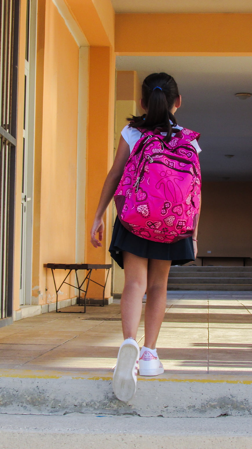 Young Girl Walking Away with Pink Backpack