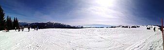 Panoramic View of Snowy Alpine Ski Slope with Mountains