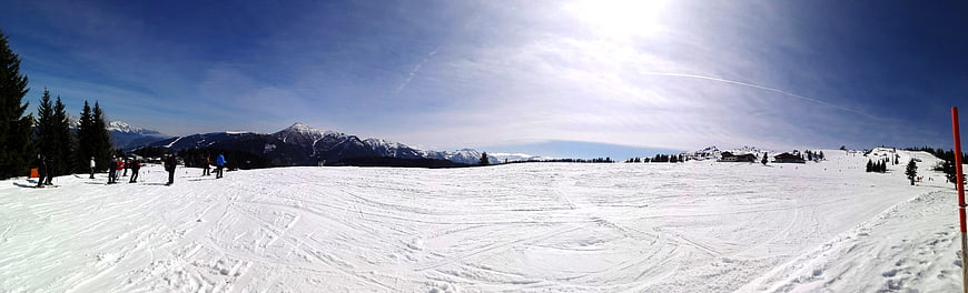 Panoramic View of Snowy Alpine Ski Slope with Mountains
