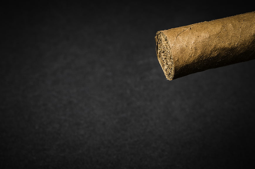Close-up of a cut cork cylinder on a dark textured background