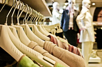 Clothing on hangers in a fashion boutique store