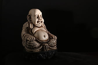 Ivory Laughing Buddha Statue on Dark Background