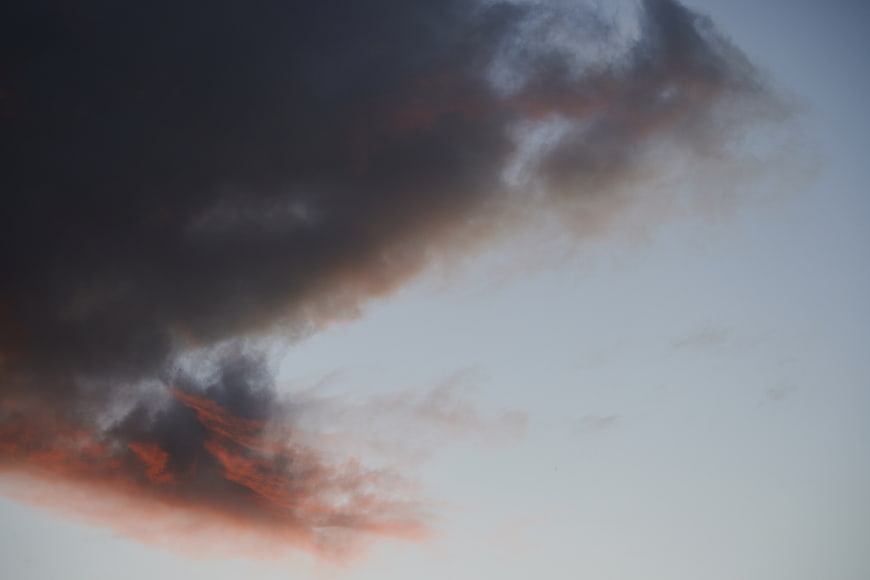 Dramatic Dark Clouds with Pink Sunset Highlights