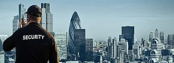 Security Guard Monitoring London City Skyline