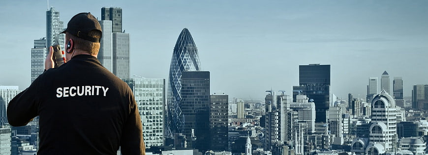 Security Guard Monitoring London City Skyline