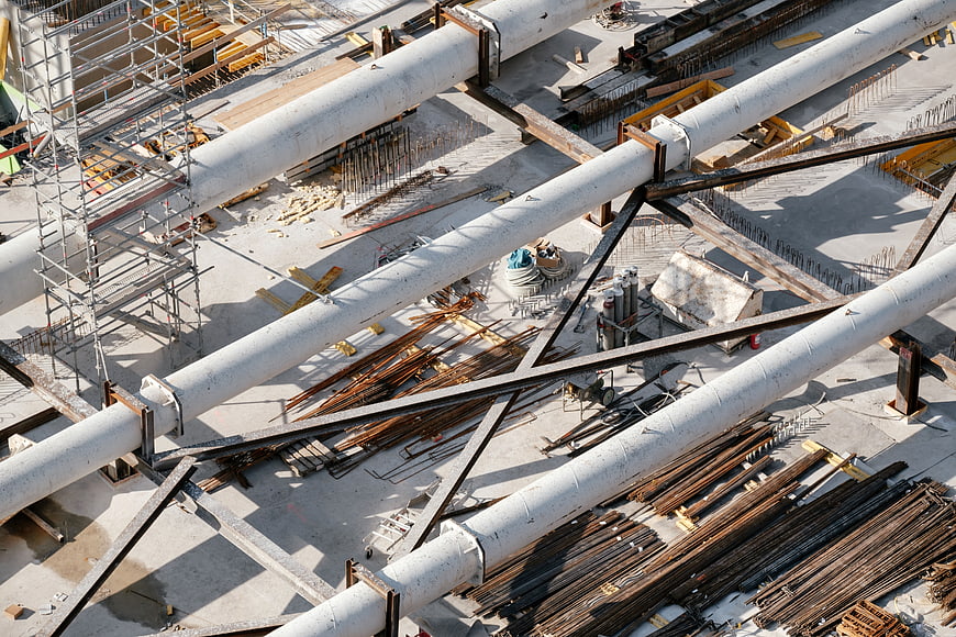 Aerial view of construction site with steel beams and scaffolding