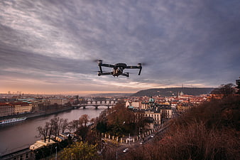 Drone Flying Over Prague Cityscape at Sunset