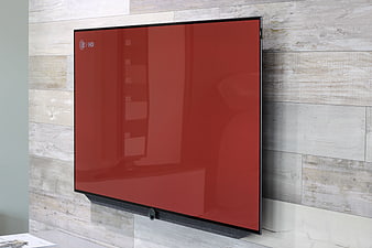 Modern flat-screen TV with red display mounted on wood wall