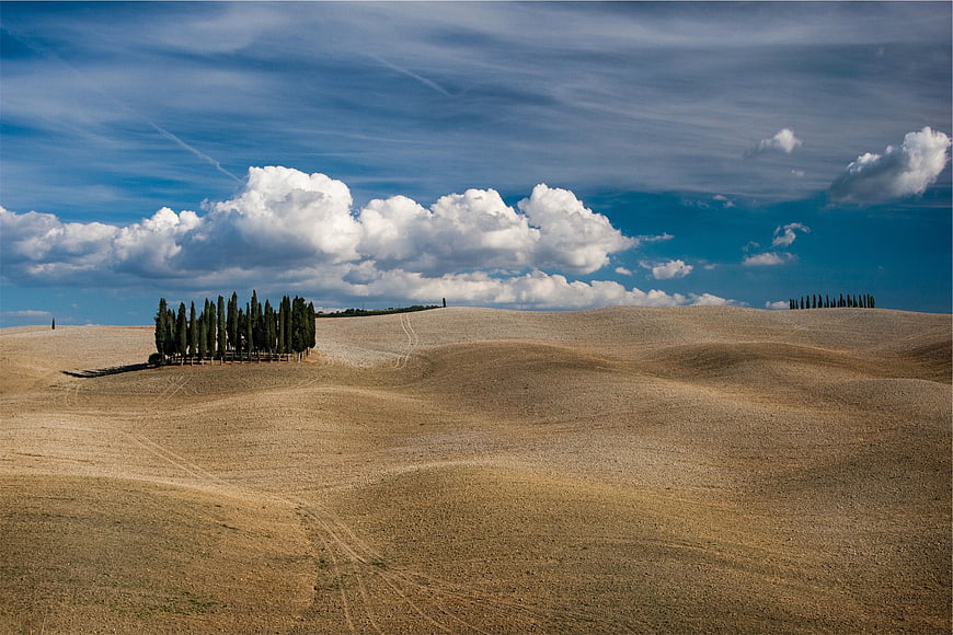 Rolling Tuscan Hills with Cypress Trees and Blue Sky
