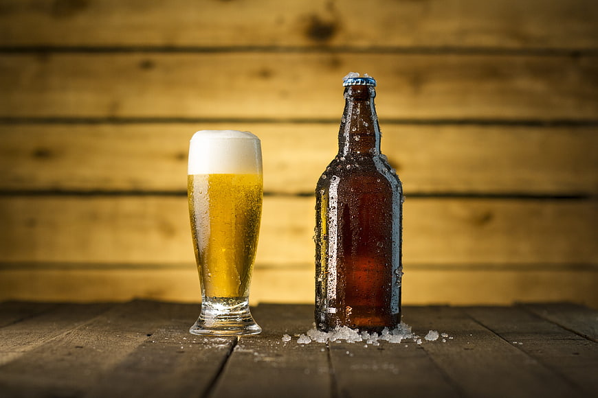 Chilled Craft Beer Bottle and Glass on Rustic Wooden Table