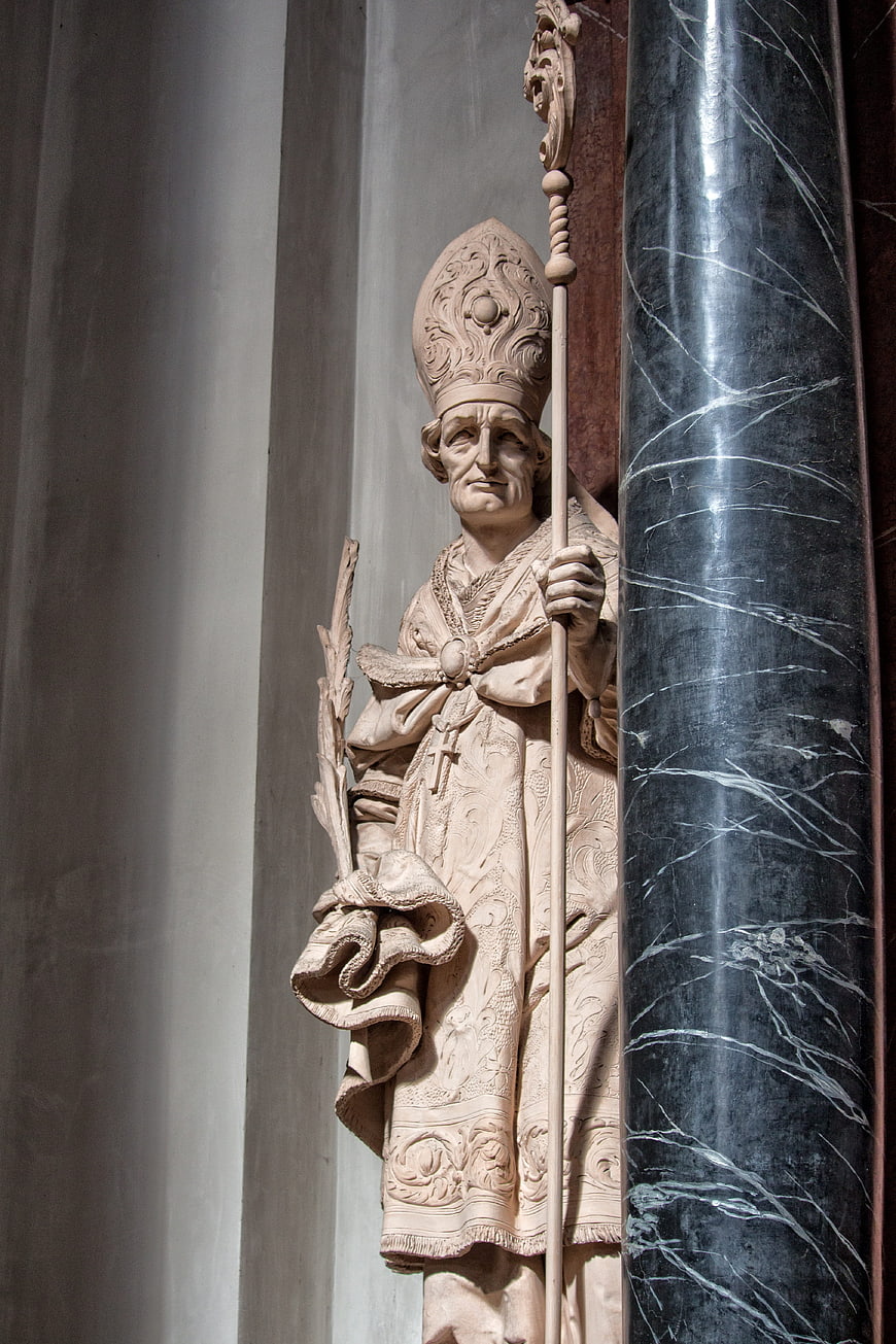 Baroque stone statue of a bishop holding a staff