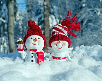 Cute Christmas Snowman Couple Figurines in Snowy Winter Forest
