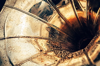 Close-up of wet brass trumpet with water droplets