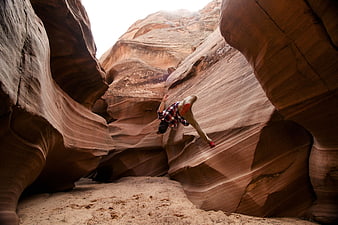 Man Parkour Jumping in Red Rock Slot Canyon
