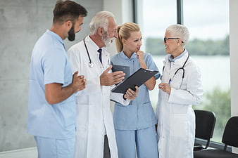 Medical team discussing patient records in hospital