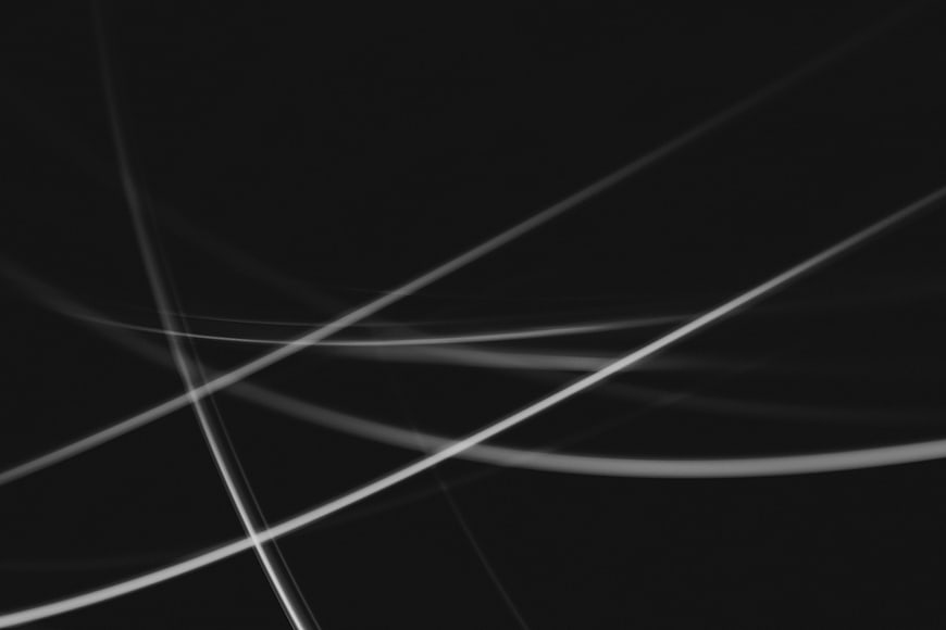 Abstract white light streaks on black background