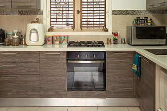 Modern kitchen interior with brown cabinets and appliances