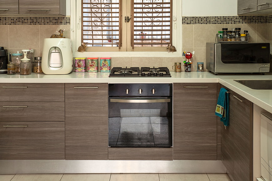 Modern kitchen interior with brown cabinets and appliances