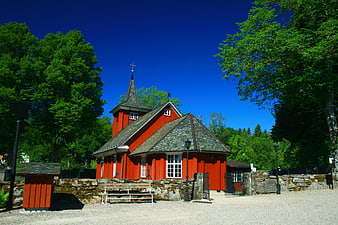 Red wooden church in Sweden with blue sky