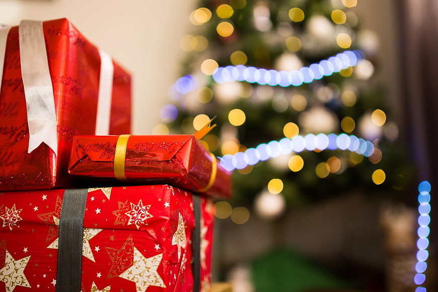 Red Christmas Gifts with Bokeh Tree Lights Background