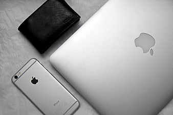 Silver Apple iPhone and MacBook with Black Wallet on White Background