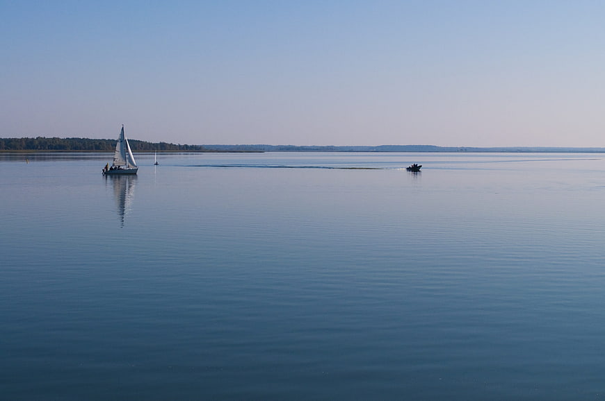 Sailboat and Motorboat on Calm Blue Lake