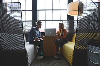 Young business colleagues collaborating in modern office lounge