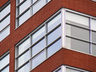 Modern Red Brick Building Facade with Large Glass Windows