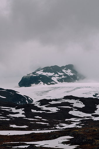Misty Snow-Capped Mountain Peak in Winter Landscape