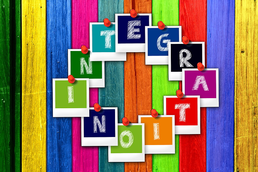 Integration concept with colorful polaroid photos on wooden background