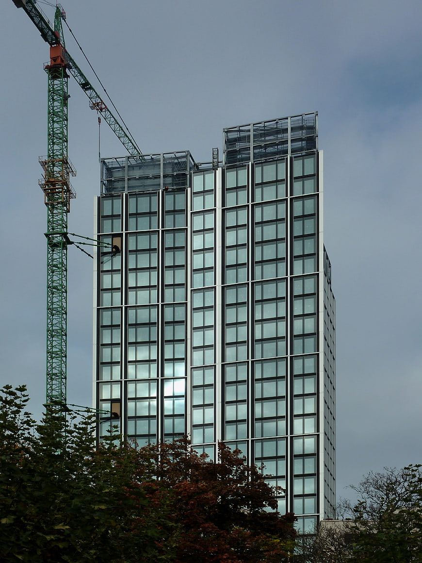 Modern Glass Skyscraper Under Construction with Crane